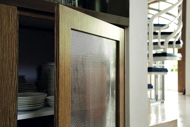 Karina used wire mesh on the kitchen cabinets to keep them ventilated.