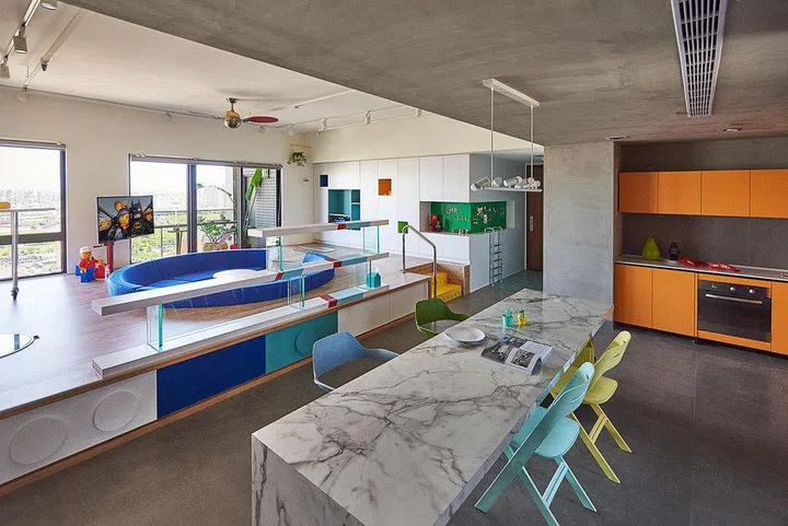 Despite its playful theme, the apartment doesn't give off a childish vibe. Loud colours are muted by tasteful and timeless tones of wood and marble. 