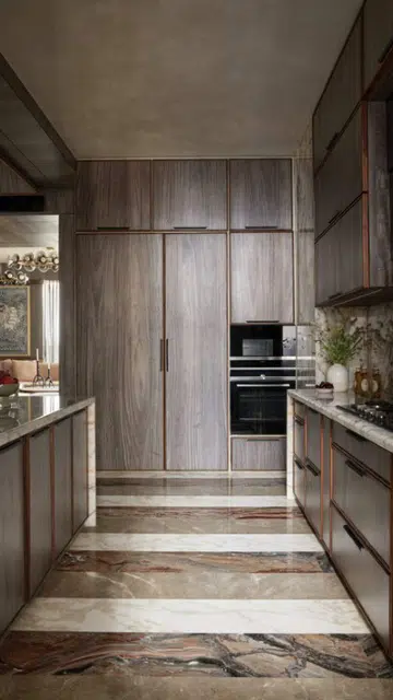 Wood tones bath the open kitchen, providing a relaxing atmosphere in this utilitarian space. 