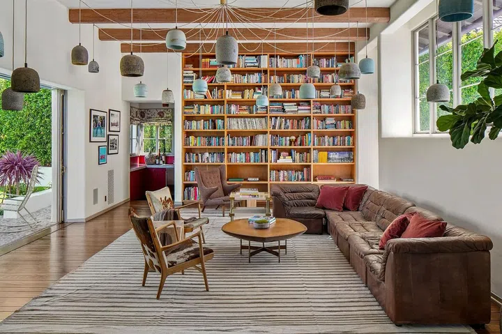 The voluminous family room sports floor-to-ceiling bookshelves.