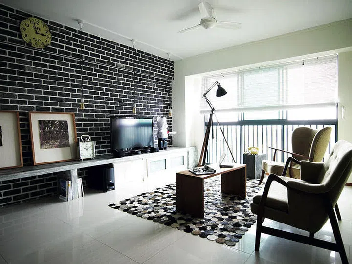 The original salmon-coloured wall was redone in a darker shade for a cooler, more industrial look and the result is a meticulously painted faux brick wall. Interior design by Three-D Conceptwerke.