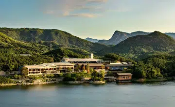 Bird's eye view of the hotel, Yanbai Villa, in the outskirts of Beijing against a green, mountainous landscape. Image from Small Luxury Hotels Yanbai Villa website.