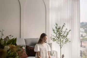 Homeowner of the 3-bedroom condominium in Tanglin (1,399 sq ft) poses for a photo in the living room Interiors designed by Studio HP.
