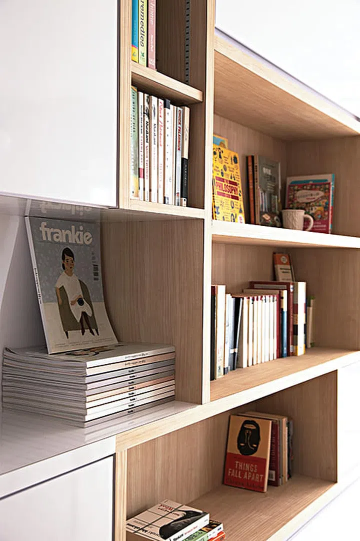 This bookshelf by the main entrance reveals the homeowner’s learned taste in authors. Interior design by Free Space Intent