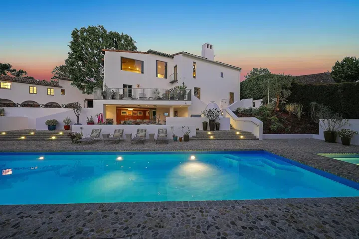 A full-size pool anchors the landscaped grounds.