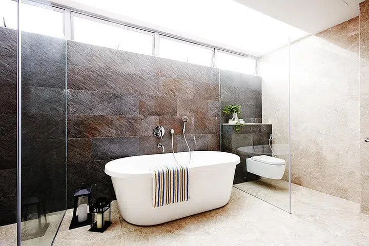 The bathroom in this four-bedroom three-storey terrace house in Mandai is bright, airy and spacious with a spa-like feel. Interior Design: Habit