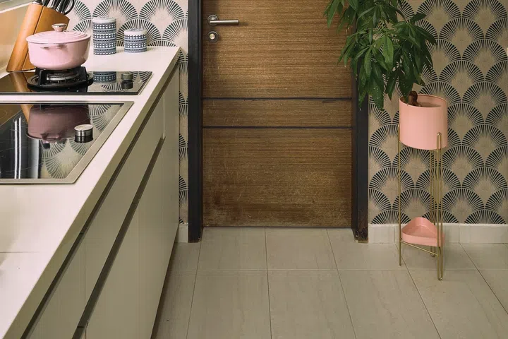 A beautiful gingko patterned wallpaper clads the wet kitchen walls.