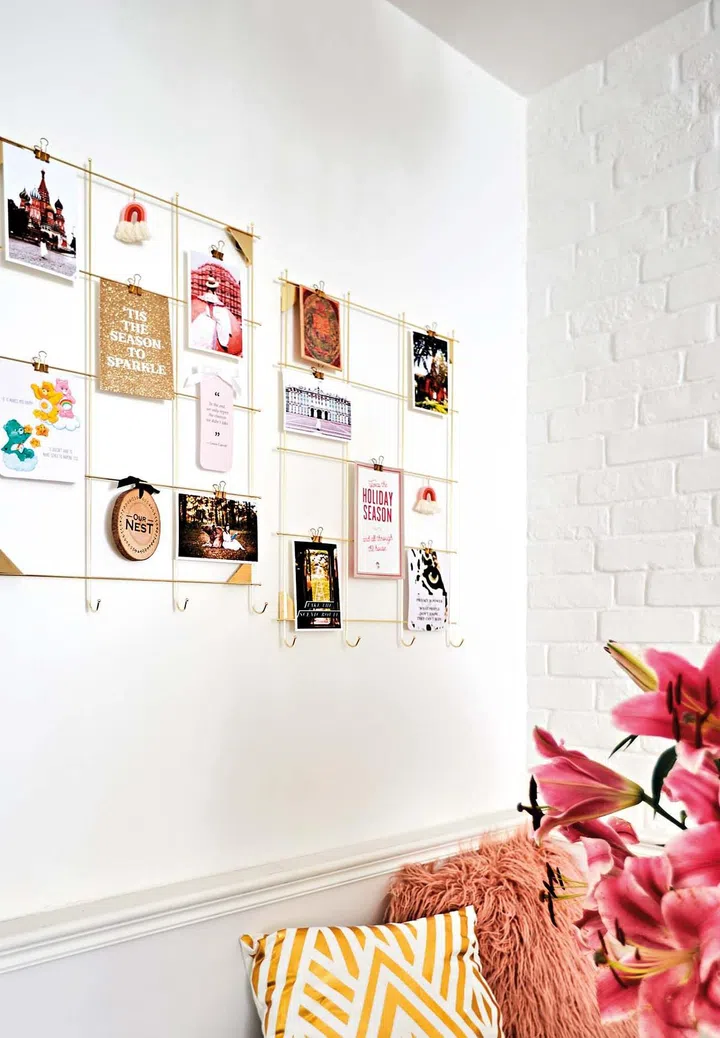 Various paper stationery, like birthday and thank you cards, hung on this simple wall- mounted wire hanger make for great wall decoration in the dining room.