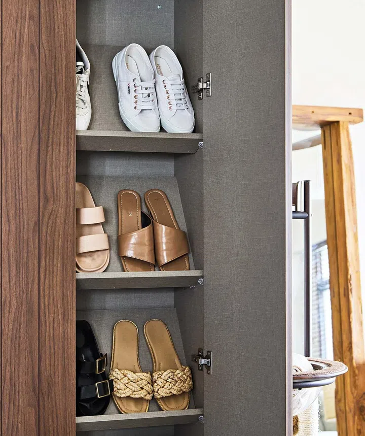 A concealed shoe rack by the entrance checks both practical and aesthetic considerations.