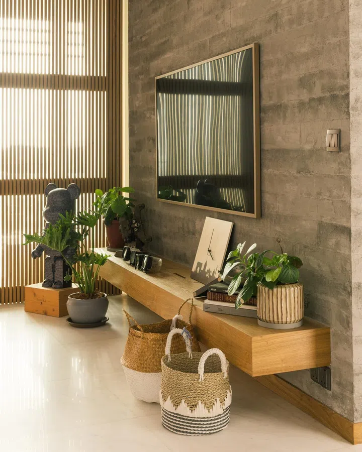 All wood TV console feature wall in a 1,900 sq ft 3-bedroom condominium in Sentosa for a young couple and their two cats.