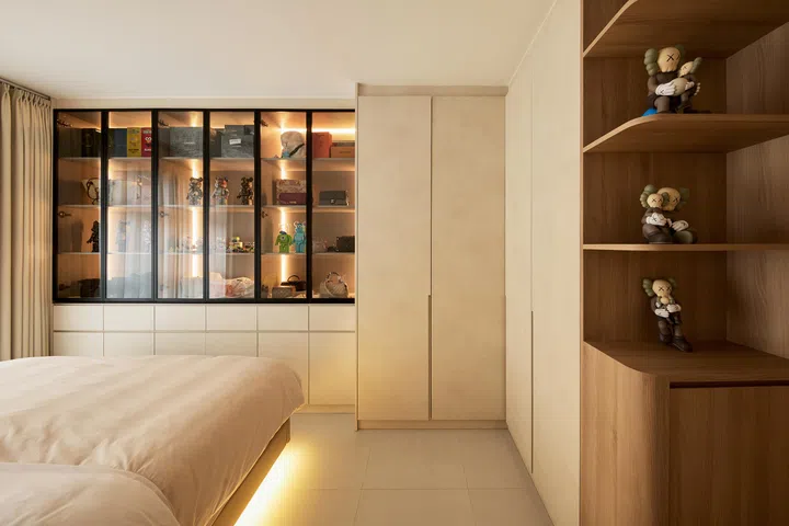 The master bedroom balances calm minimalism with a playful display of Bearbricks and handbags.