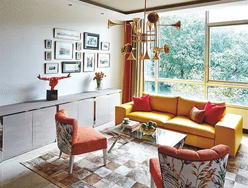 The sofa in the living room was reupholstered in bright yellow leather. The Design Intervention team says that it gives an optimistic vibe, and sets the tone for the rest of the home. 
