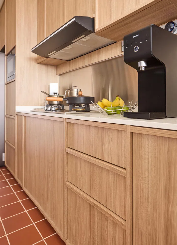 Every detail was considered, from widened cabinet hinges to a pull-out gas tank tray sourced from Malaysia for everyday ease.