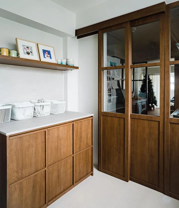 Wooden sliding
doors and
cabinetry add a
touch of rustic
minimalist feel
to the kitchen
area.