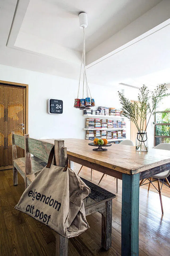 A rustic wood dining bench with a backrest. Interior design by Make Room