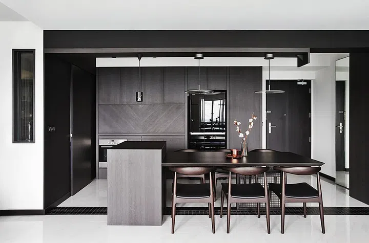 All the built-in carpentry is finished in a dark-woodgrain laminate. However, the grain is oriented differently on various surfaces - for example, diagonally on this cabinet panel in the dry kitchen - to keep the flat surfaces interesting.