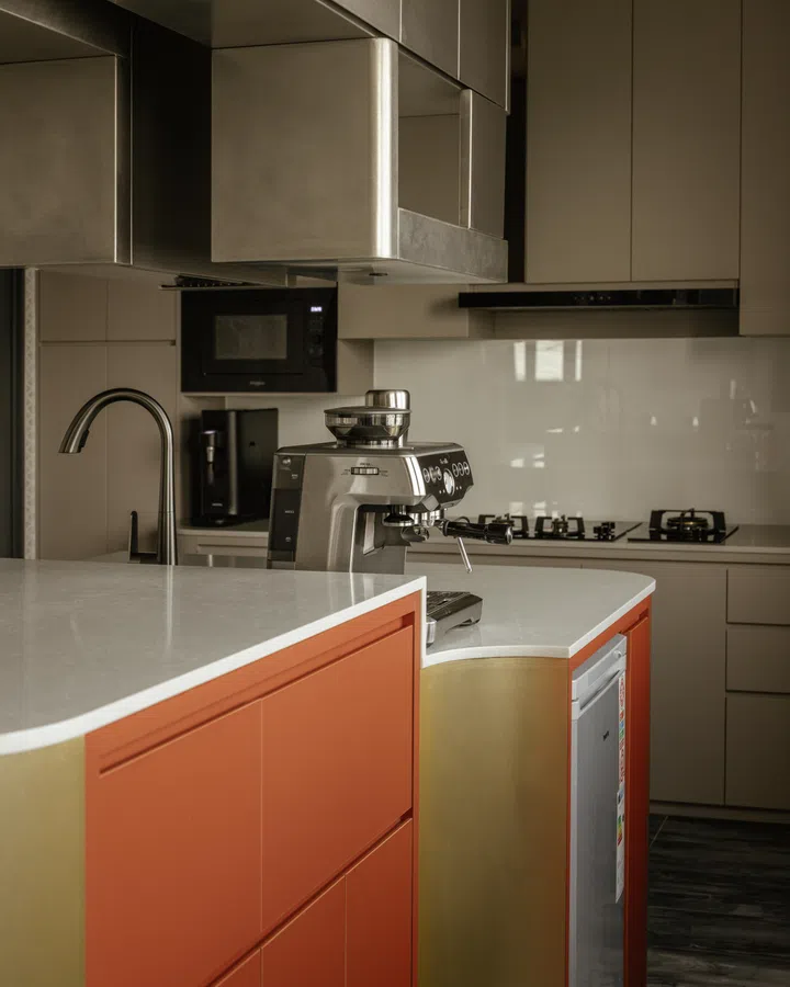 The island is custom-built with integrated services and storage, reflecting the home’s high-spec, purpose-driven approach.