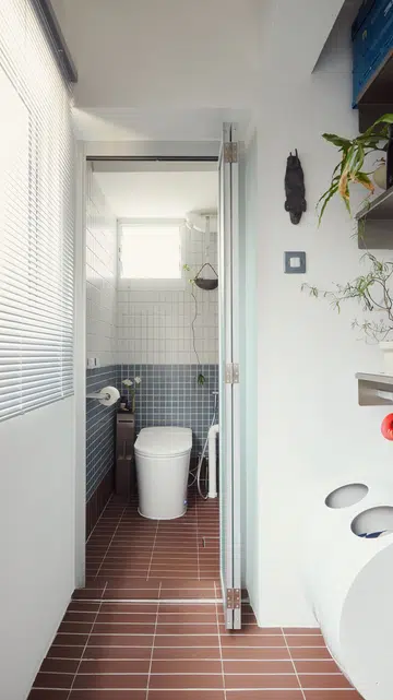 A smart toilet bowl takes its place in an old-school HDB split-bathroom layout.