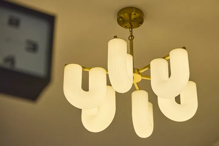 Hanging lights sourced from Hock Siong lend warmth and a layered, lived-in quality to the dining space.