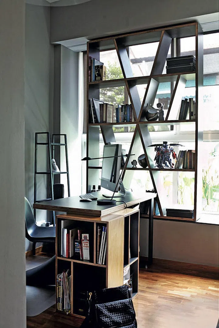 Alan left the front edges of the plywood shelves bare for textural contrast. The sliding bookshelf maximises the bay window by turning it into much-needed storage space.