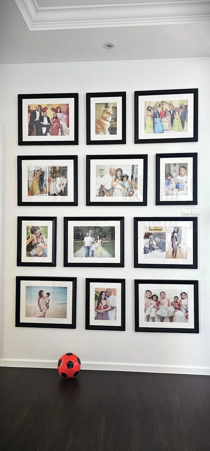 A wall filled with framed family photographs in a 3-bedroom condo along Balestier Road.