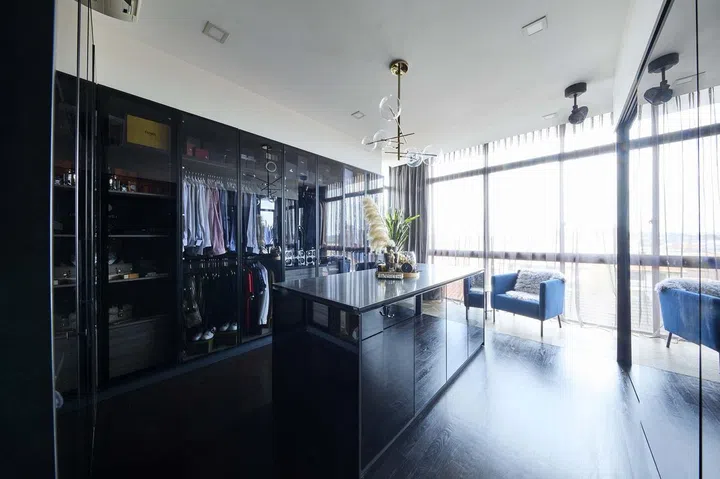 The walk-in wardrobe has a central island just like a luxury fashion boutique in interior designer Cheryl Gay of Coterie Design's 3,600 sq ft semi-detached home in Yio Chu Kang.