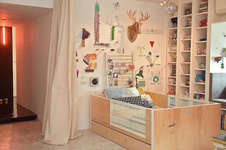 The child's bed (above) is built by Mr Cheok using plywood and fitted with slats from her baby crib.