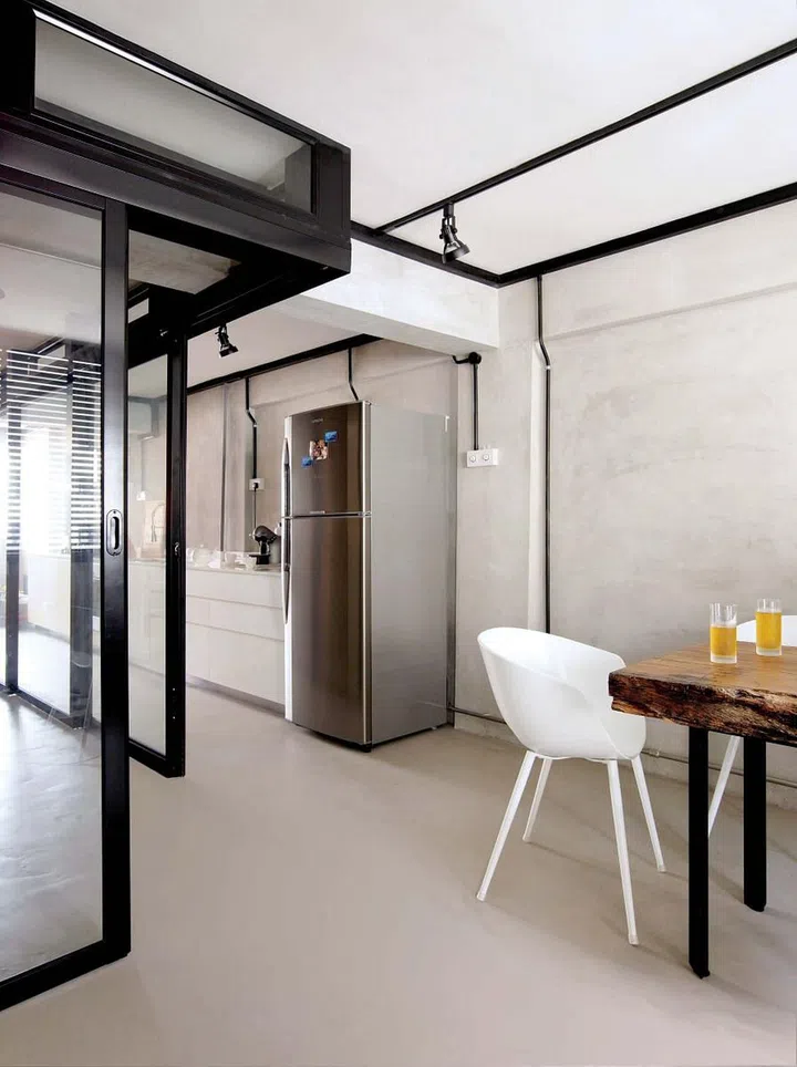 Dining and kitchen in a 700 sq ft 3-room HDB bachelor's pad.