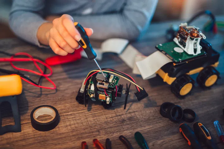 Girl constructs technical toy, close up