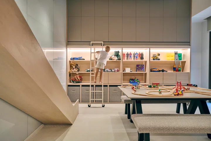 Scaled for children yet designed with longevity in mind, the storage wall invites both play and independence.