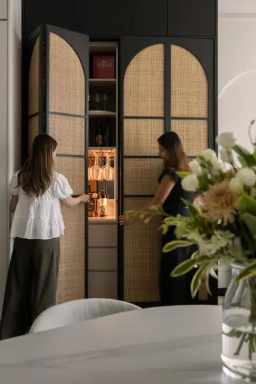 The arched rattan cabinet door design creates a striking focal point for the home.