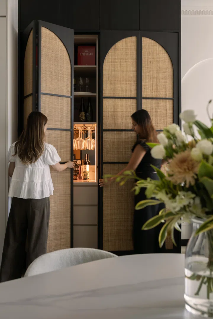 The arched rattan cabinet door design creates a striking focal point for the home.