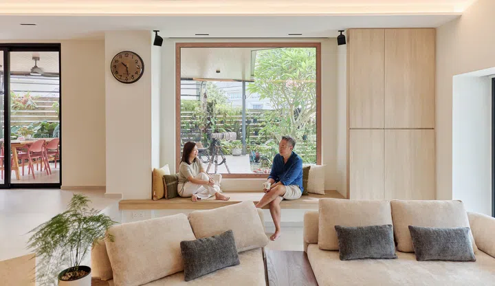 Framing the lush garden beyond, the window seat has become a favourite place for quiet conversations and moments of reflection.
