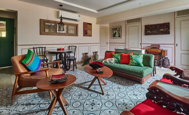 The eclectic living area, anchored by patterned floor tiles and a plush green sofa framed by warm wooden accents in a 4-room HDB resale in Sunset Way.