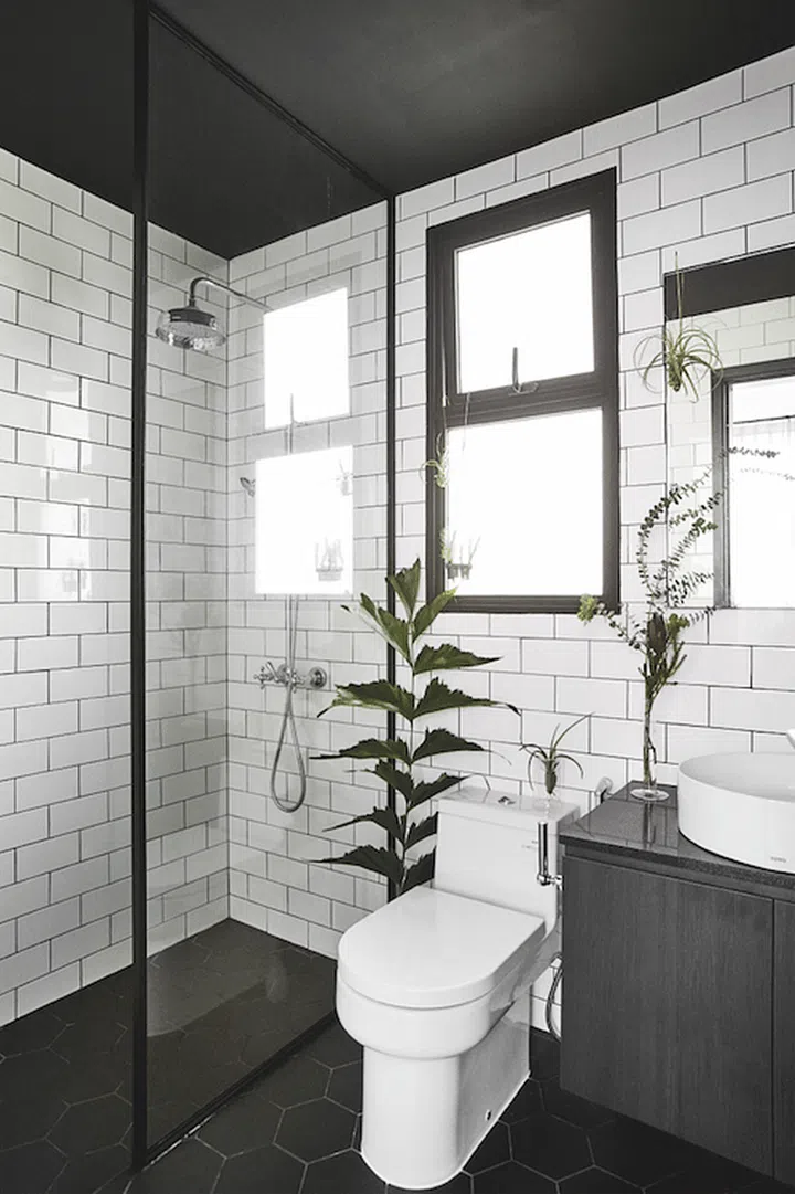 White subway tiles for the bathroom walls, and black hexagonal tiles for the floors.