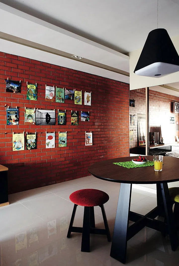 The arrangement of Tintin covers on the wall adds to the home’s eclectic feel. Playful shapes and colour give the dining area a relaxed atmosphere.