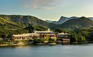 Bird's eye view of the hotel, Yanbai Villa, in the outskirts of Beijing against a green, mountainous landscape. Image from Small Luxury Hotels Yanbai Villa website.