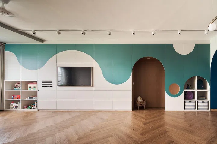 TV feature wall in the living room with plenty built-in storage stretching across the house in this 1,592 sq ft HDB executive apartment in Queenstown.