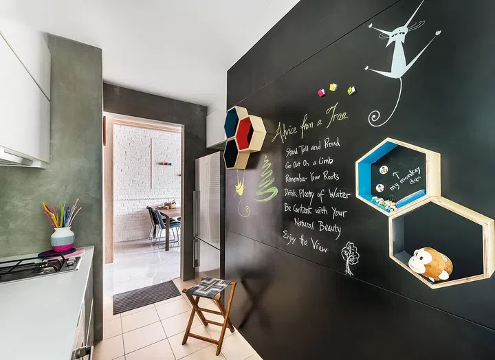 The kitchen’s feature wall is a magnetic sheet that’s been spray-painted to serve as a chalkboard, too.