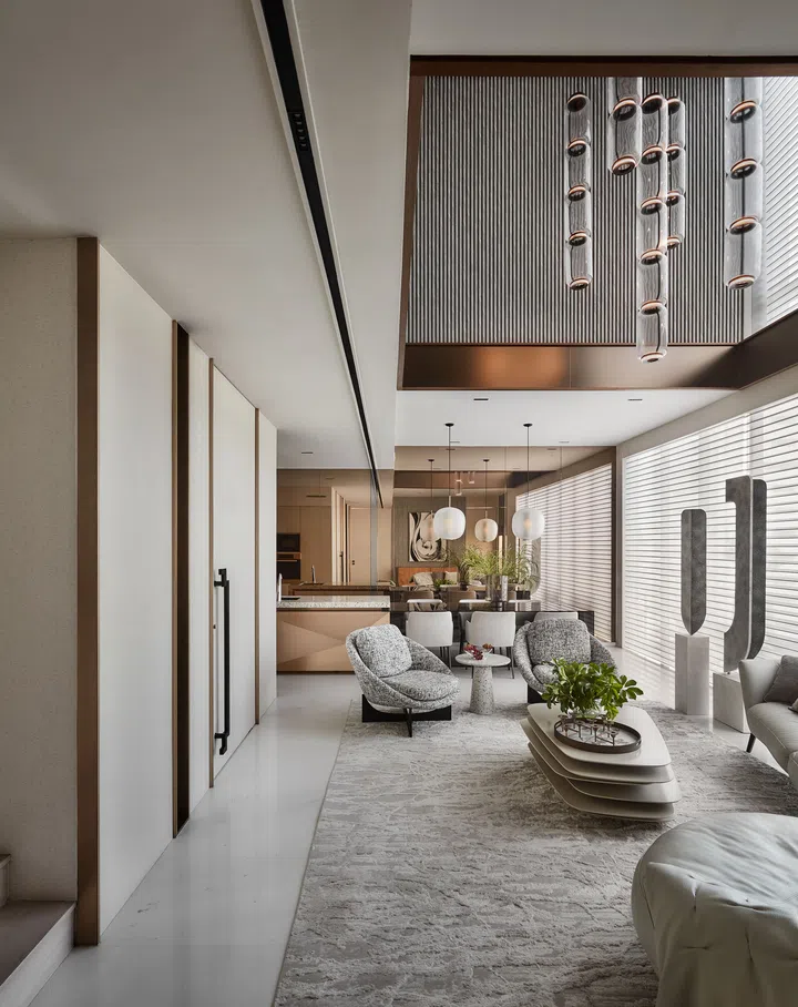 The muted off-white and beige colour palette with accents of bronze and matte and mirrored finishes give the penthouse apartment a stylish look.