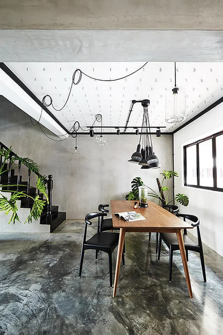 The utilitarian order of hooks prevents the ceiling from looking too overwhelming in this 3-bedroom HDB Maisonette in Serangoon.