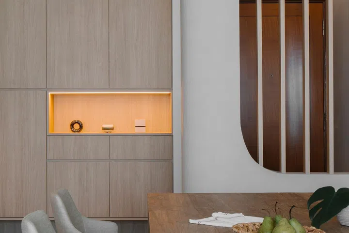 Curved carpentry and designs are prominent in this young lawyer couple's 3-bedroom condominium in Bishan.