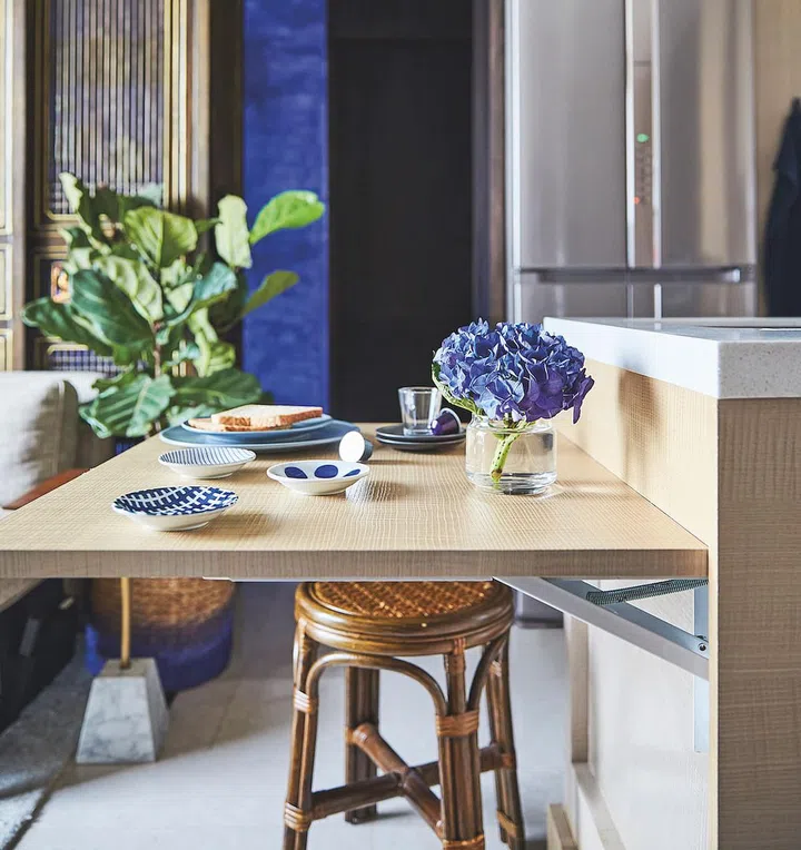 Drop leaf kitchen island can be used as a workstation, dining table and storage unit.