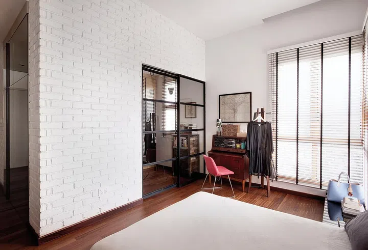 The study area behind the glass doors used to be an en suite bathroom.