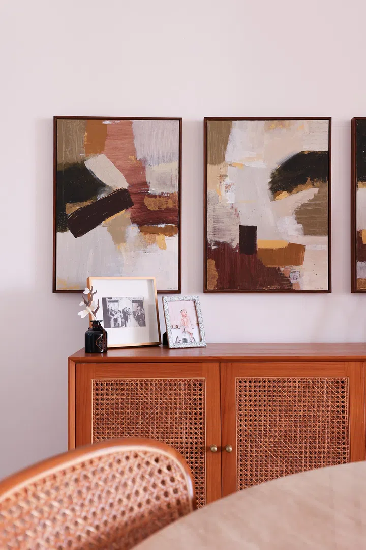 Rattan chairs add texture and tactility to the Japandi-Scandinavian dining space.