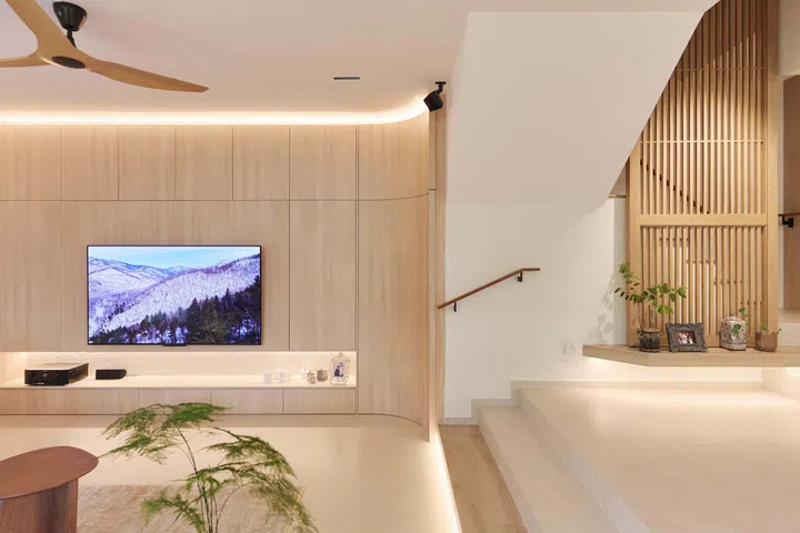 One of Janice’s favourite details is the concealed storeroom tucked beneath the staircase, accessed through a curved door seamlessly integrated into the TV feature wall.