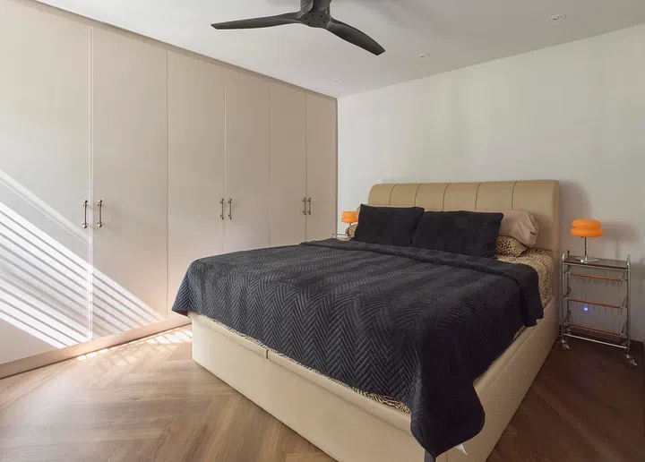 The master bedroom is kept simple and uncluttered, with built-in storage and a neutral palette for rest.