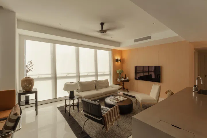 Soft-filtered light through roller blinds from Coulisse maintains privacy while preserving the apartment’s airy, open feel.