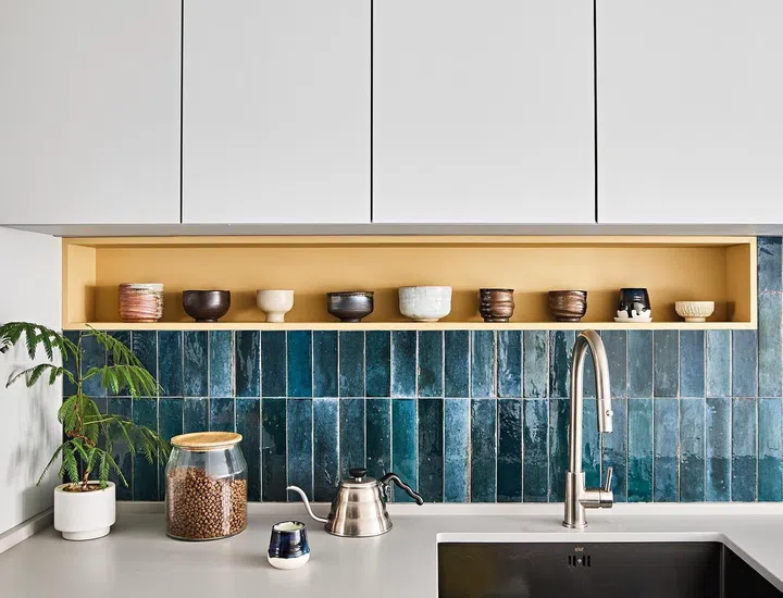 Navy blue subway tiles on the backsplash