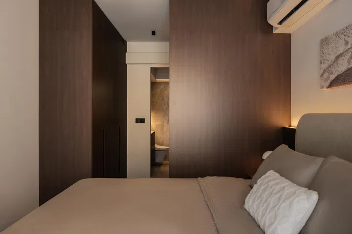 Walk-in wardrobe in the master bedroom in a 5-room HDB BTO at Tampines Street 96 (1,216 sq ft), designed by Inizio Atelier.